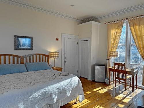 a bedroom with a bed and a desk and window at Christopher Dodge House in Providence