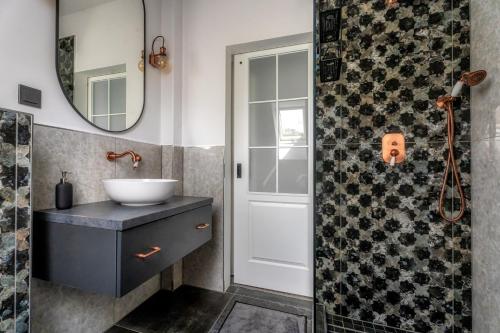 a bathroom with a sink and a mirror at Villa Viktória in Balatonfüred