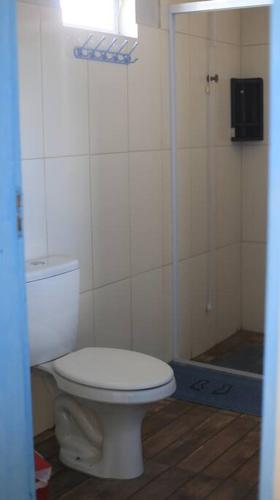 a bathroom with a toilet and a shower at Casa de praia - Descanse e tenha uma experiencia relaxante a poucos metros da praia in Arroio do Silva