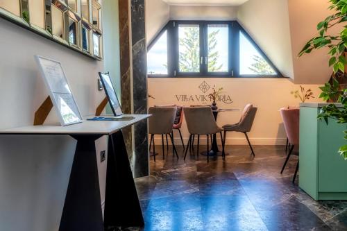 a room with a table with a laptop on a counter at Villa Viktória in Balatonfüred
