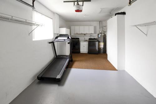 an empty room with a treadmill in a kitchen at Paradise with private pool Sleeps 10 near the beach in Sunrise
