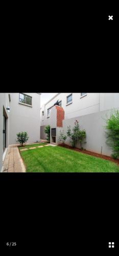 a picture of a house with a grass yard at KWT property in Soweto