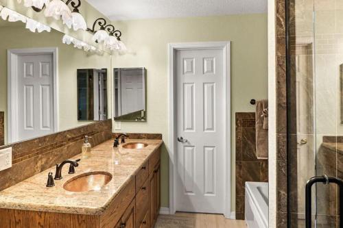 a bathroom with two sinks and a large mirror at Spacious W Sedona 4 bedroom Contemporary House! in Sedona
