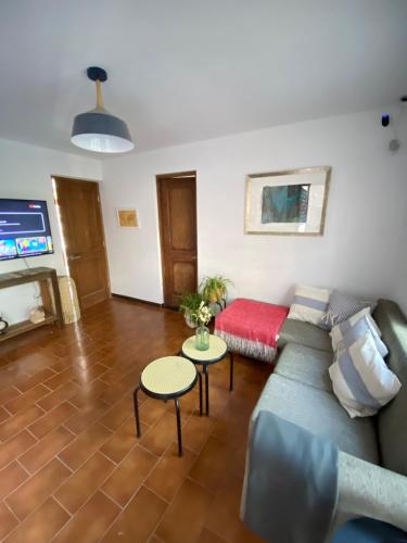 a living room with a couch and a tv at Casa Guemes in Santiago