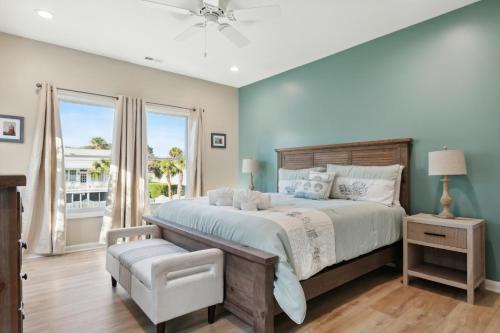a bedroom with a large bed and a window at BeachZilla - 907 East Arctic in Folly Beach