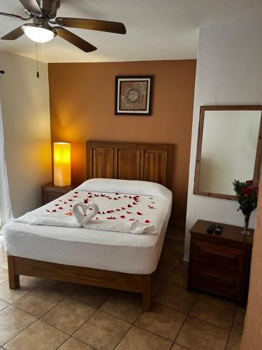 a bedroom with a bed with two swans on it at Hotel Jardín del Cantador in Guanajuato