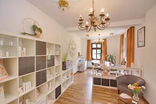 a living room with a large book shelf at Gasthof und Pension Hammerschänke in Wildenthal