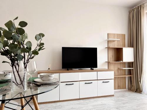 a living room with a tv and a table at Seaside apartment Tyndzha in Pomorie