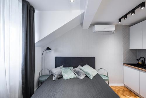 a bedroom with a bed with two pillows at Pistachio apart City center in Novi Sad
