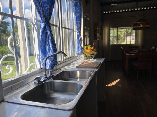 uma cozinha com um lavatório e uma janela em El Hogar del Torogoz em Concepción de Ataco