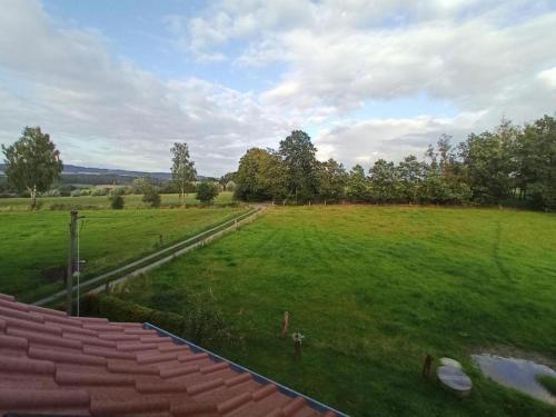 a view of a large green field with trees at Erholen und Wohlfühlen Auf dem Knick in Detmold