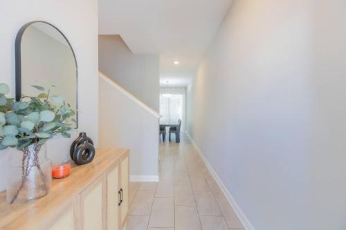 a hallway with white walls and a vase of flowers at Family 4BR w Private Pool near Disney Parks in Kissimmee