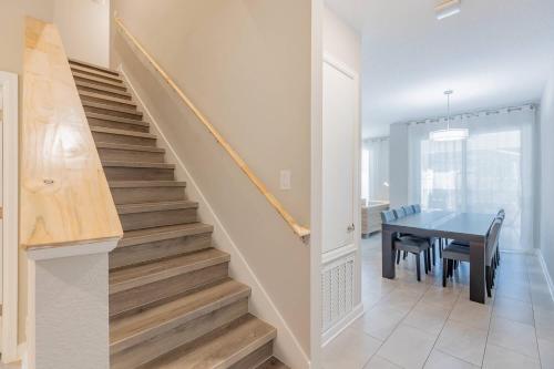 a staircase in a home with a table and a dining room at Family 4BR w Private Pool near Disney Parks in Kissimmee