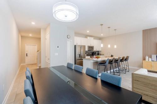 a dining room and kitchen with a table and chairs at Family 4BR w Private Pool near Disney Parks in Kissimmee