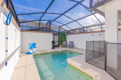 an indoor swimming pool with a glass roof at Family 4BR w Private Pool near Disney Parks in Kissimmee