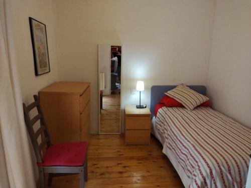 a bedroom with a bed and a table and a chair at Can Penjarella I in Arbúcies