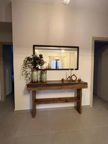 a mirror on a wall with a wooden table at Mountain Retreat I - Karpenisi in Karpenision