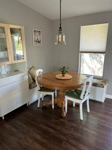 a dining room with a wooden table and chairs at Eastside Costa Mesa house in Costa Mesa
