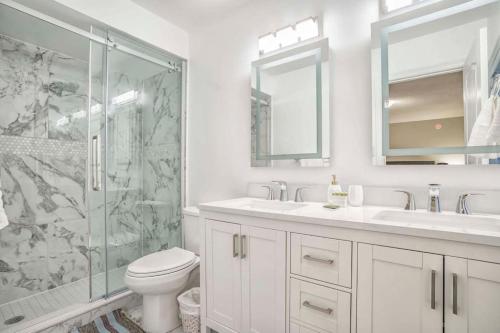 a bathroom with a shower and a toilet and a sink at Designer 4BR Executive Townhome w/Parking in Mississauga