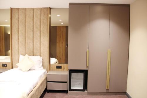 a bedroom with a bed and a large wardrobe at Sabiha Sultan Hotel-Karakoy in Istanbul