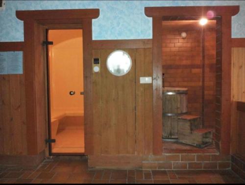 an open door in a room with a brick wall at Ploner villaggio Turistico in Dobbiaco