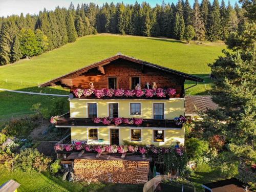 an aerial view of a house with flowers on it at Kohlegghof in Schwemmberg