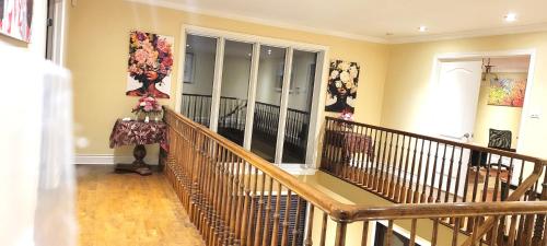 a room with a staircase with a wooden railing at Lady Eden Waterfront Mansion - No party in Montréal