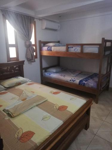 a bedroom with two bunk beds and a window at Casa Madrigueña in Rincón