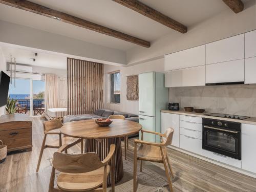 a kitchen and living room with a table and chairs at Cancun Deluxe Apartment in Chania Town