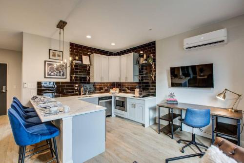 a large kitchen with blue chairs and a table at VRAIN 2 Bedroom 1 Bath with Full Kitchen in Denver