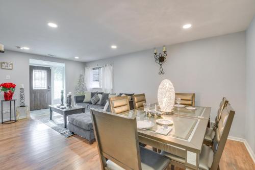 a dining room and living room with a table and chairs at Country Club Hills Home Walk to Rec Center! in Country Club Hills