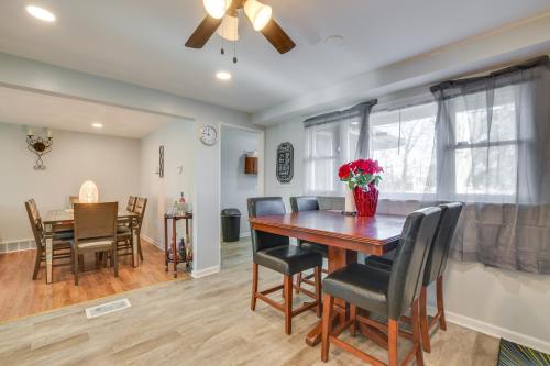 a dining room and living room with a table and chairs at Country Club Hills Home Walk to Rec Center! in Country Club Hills