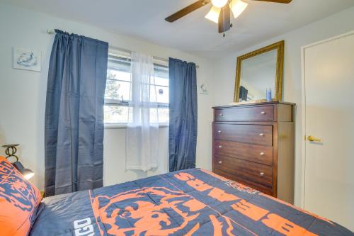 a bedroom with a bed and a dresser and a window at Country Club Hills Home Walk to Rec Center! in Country Club Hills