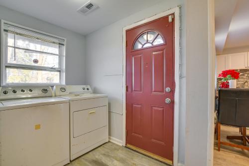 a kitchen with a red door and a sink at Country Club Hills Home Walk to Rec Center! in Country Club Hills