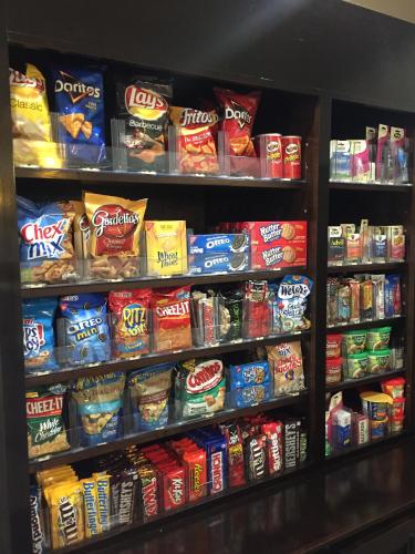 a shelf filled with lots of different types of snacks at Comfort Inn & Suites, White Settlement-Fort Worth West, TX in Fort Worth