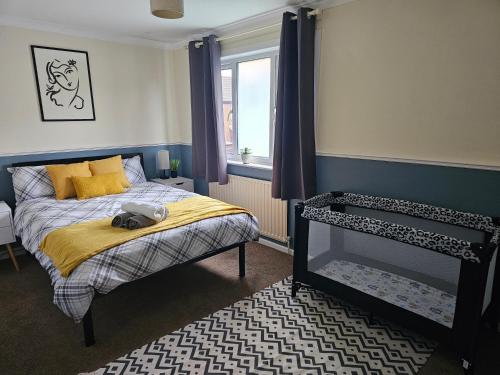 a bedroom with a bed and a window at Home in Beckton. Docklands. London City Airport. in London