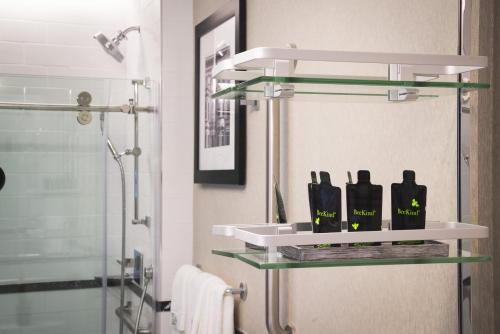 a bathroom with a shelf with bottles on it at 42 Hotel in Brooklyn