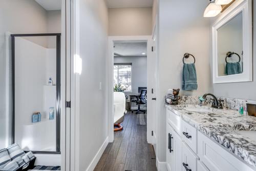 a bathroom with two sinks and a tub at Cedar City Home with Mountain Views and Hiking Trails! in Cedar City