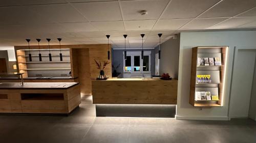 a large kitchen with a counter and a refrigerator at Hotel Am Markt in Karlsruhe