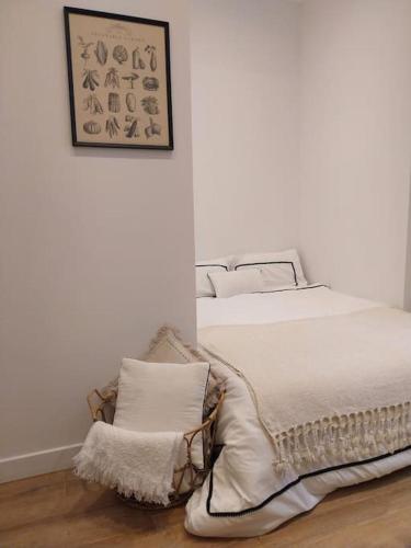 une chambre blanche avec un lit et une chaise dans l'établissement Appartement Place des Terreaux, à Lyon