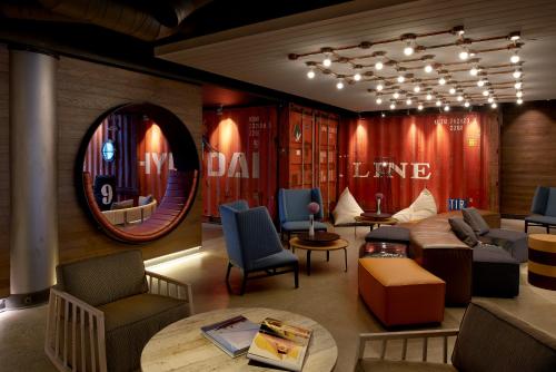 a room with couches and chairs and a mirror at Hotel Zephyr San Francisco in San Francisco
