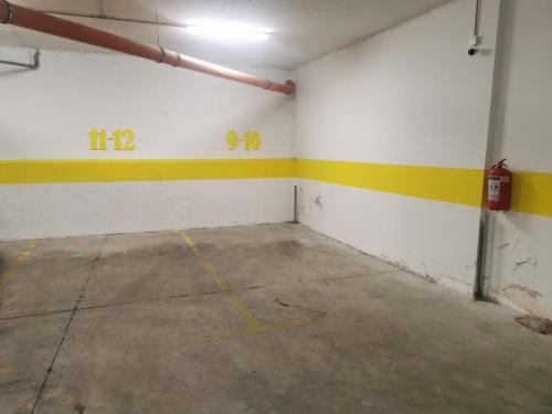 an empty garage with yellow and white walls at Amar 2 in Zemun