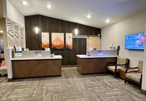 a lobby with two reception desks and chairs at Best Western Country Inn in Fortuna