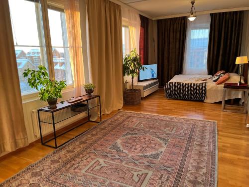 a bedroom with a bed and a rug on the floor at Garden City Apartment, Helsinki - Vantaa Airport in Vantaa