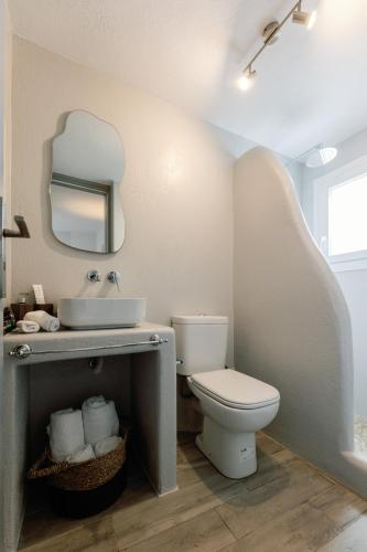 a bathroom with a toilet and a sink and a mirror at Hidden Gem Villa Aqua Marine - Sea View - Mikri Vigla Beach in Naxos Chora
