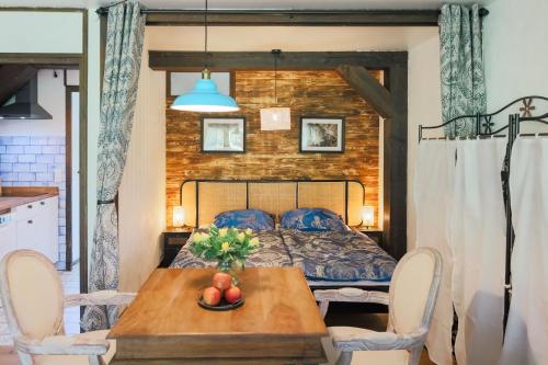 a bedroom with a bed and a wooden table at Geographer´s Suite in Siegsdorf