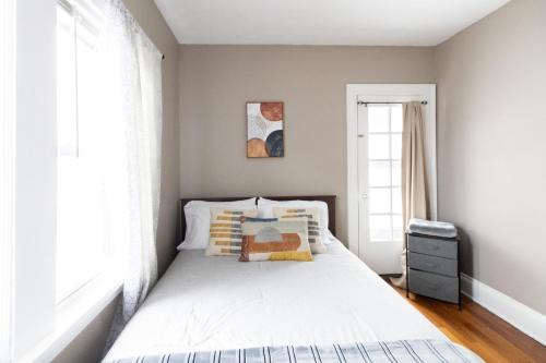 a bedroom with a bed and a window at Stylish 3-bd Haven in Trendy Cleveland Heights! in Cleveland Heights
