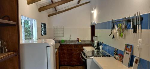 eine Küche mit einem weißen Kühlschrank und einer Spüle in der Unterkunft Casa Satori - Recanto de Paz in Alto Paraíso de Goiás