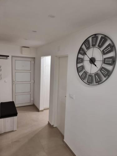 a large clock on a wall in a room at LIVNO in Livno