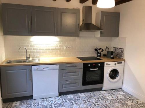 a kitchen with a sink and a washing machine at Appartement 2/3 pièces (55m²) au cœur du Vexin in Chars